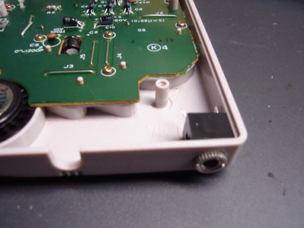 Now stop the dremel. And unscrew the end of the 1/8" jack. Try and fit it into the hole you just made.