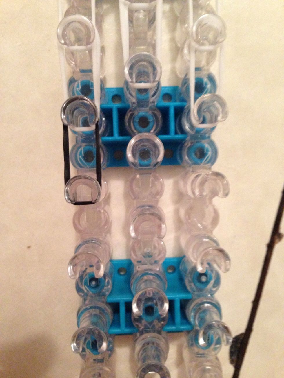 Now take 2 black bands and place down on left peg