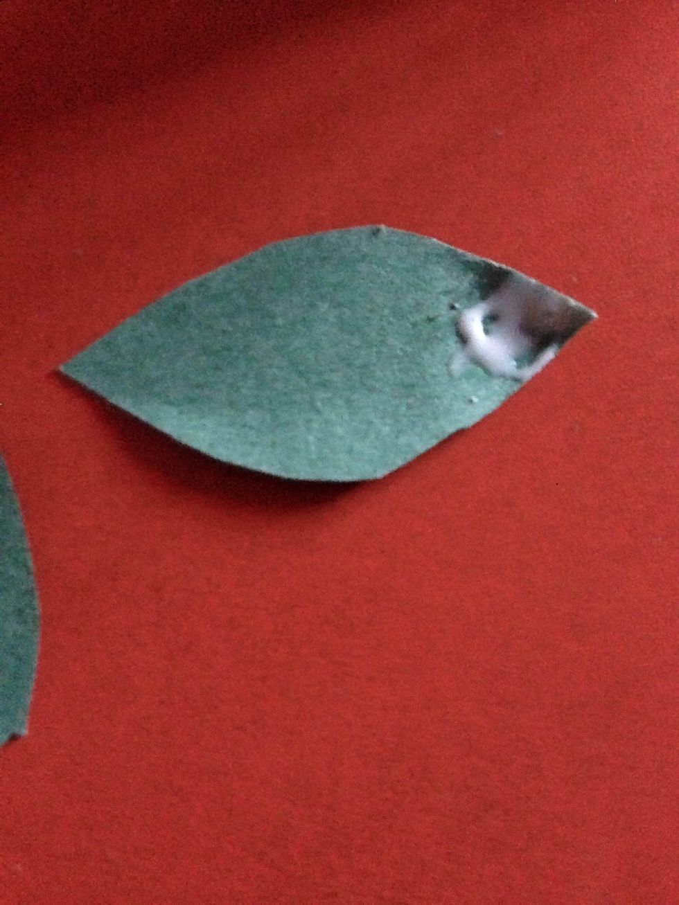 Now take a green colour paper and cut it in  the shape of leaves . Put glue as shown