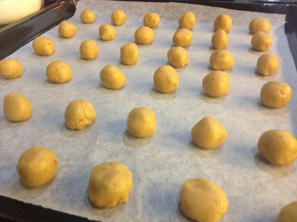 Now take a little bit of dough and roll it into a ball. I am doing cute little cookies but you could make them bigger if you want. Just keep in mind that cooking time will vary!