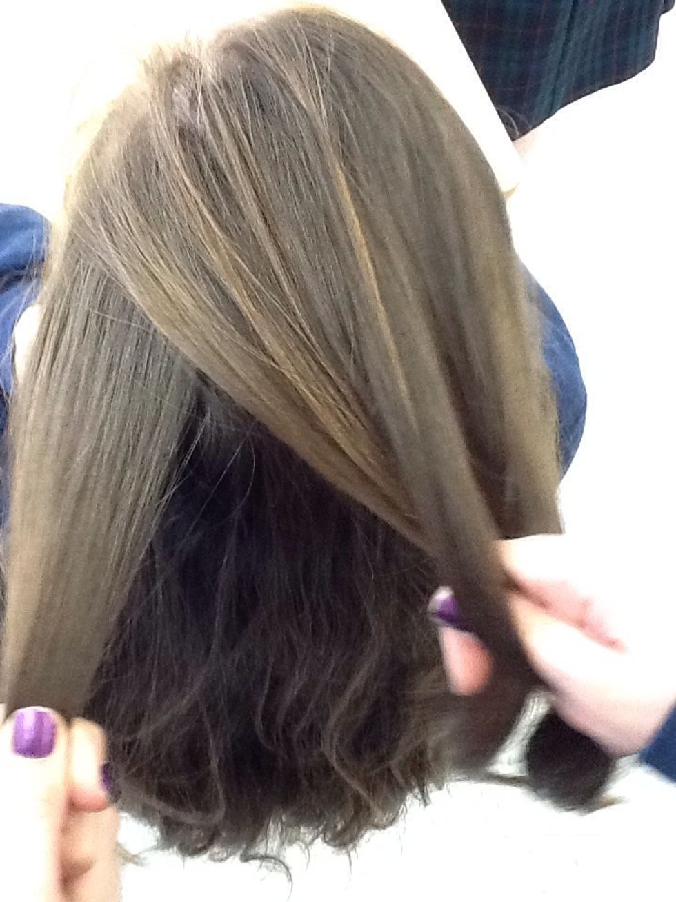 Now take a piece of hair you are not holding from the left side and put it with the piece you just crossed under