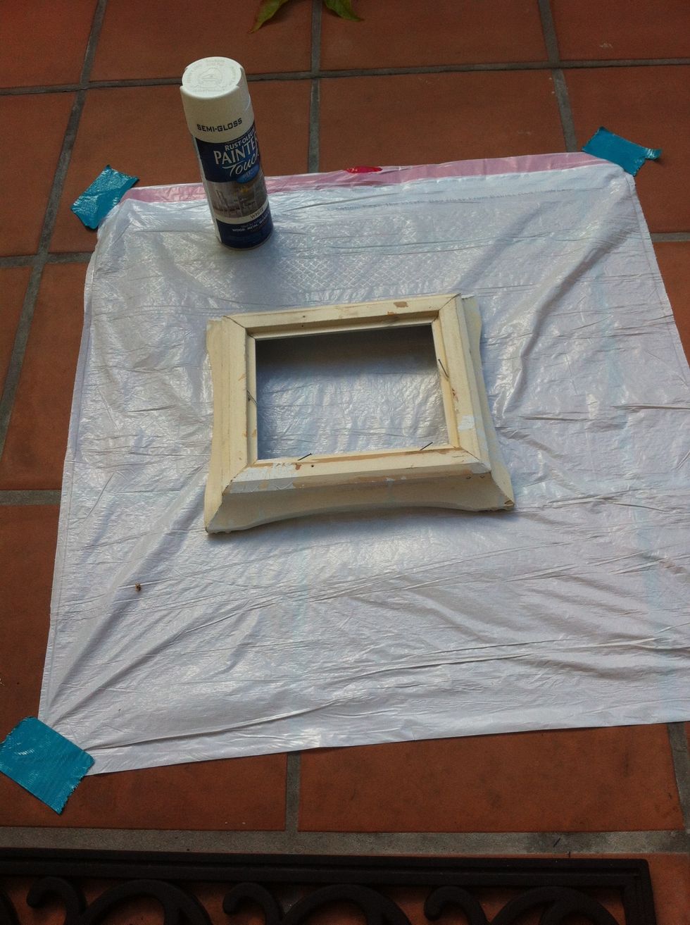 Now take a trash bag or shopping bags and lay them down flat. Place the frame in the middle of it. *Note: if it's windy outside, tape down the edges of your bags