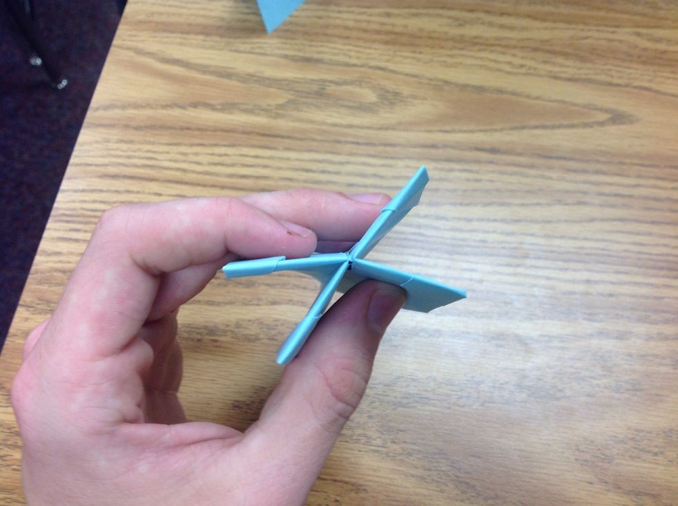 Now take and fold the sides towards one another as shown.