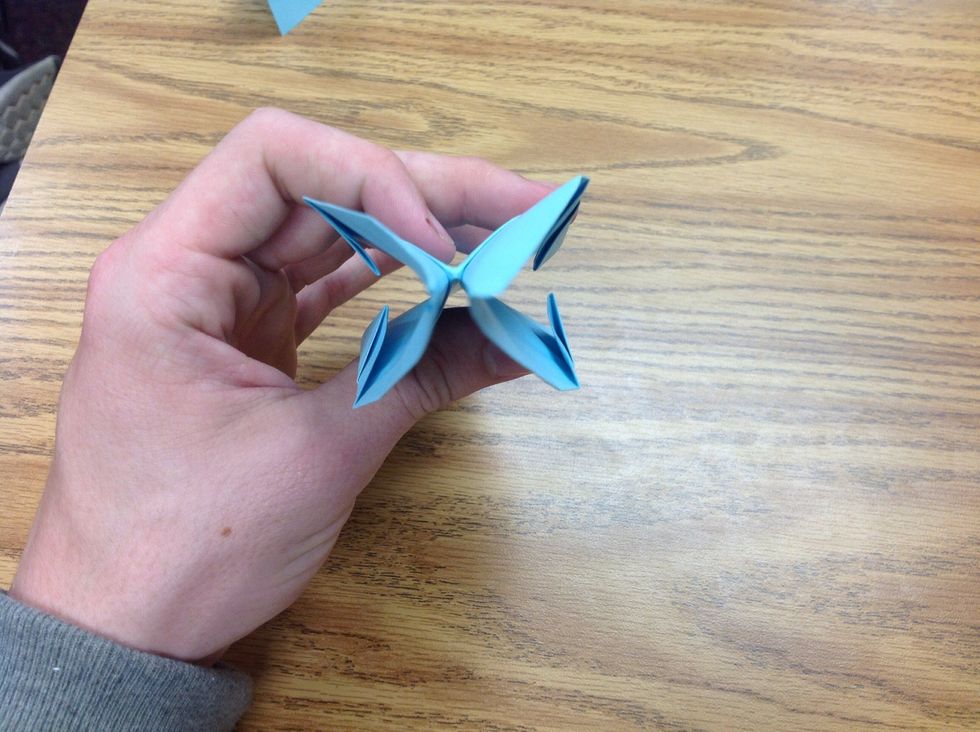 Now take and fold the three sides toward each other, and make sure that the small folds do not unfold themselves back out, they must remain folded for the rest of the steps.