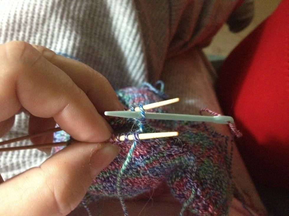 Now take needle, again purlwise, through the 1st stitch on the back needle. Pull the yarn through -- again, not too tightly.