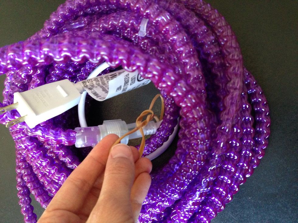 Now take one of your homemade bungee cords and place in the middle of your wrapped lights.