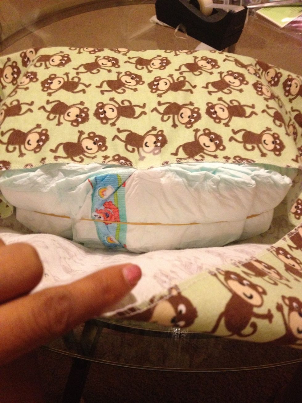 Now take one receiving blanket and wrap around all the diapers. Don't worry if its too messy. The only part that will show is the top of the bed.
