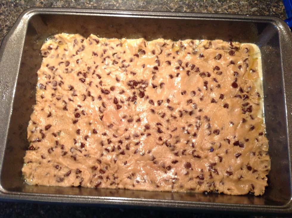 Now, take out your cookie dough and gently press it across the pan till it's about an 1/8 inch thick.