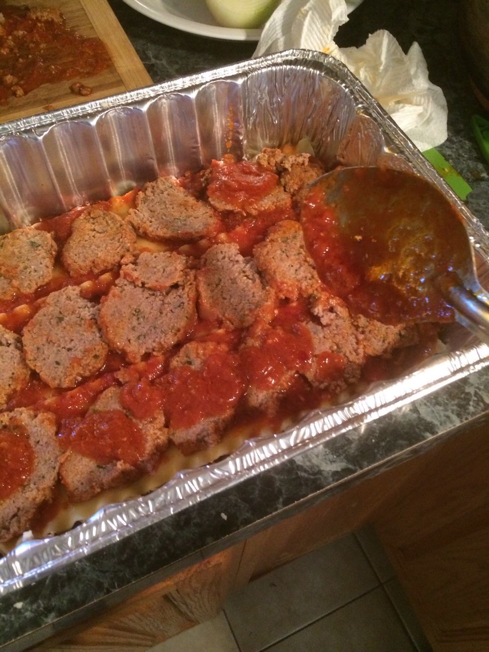 Now take some more sauce and add it to the top of each meatball