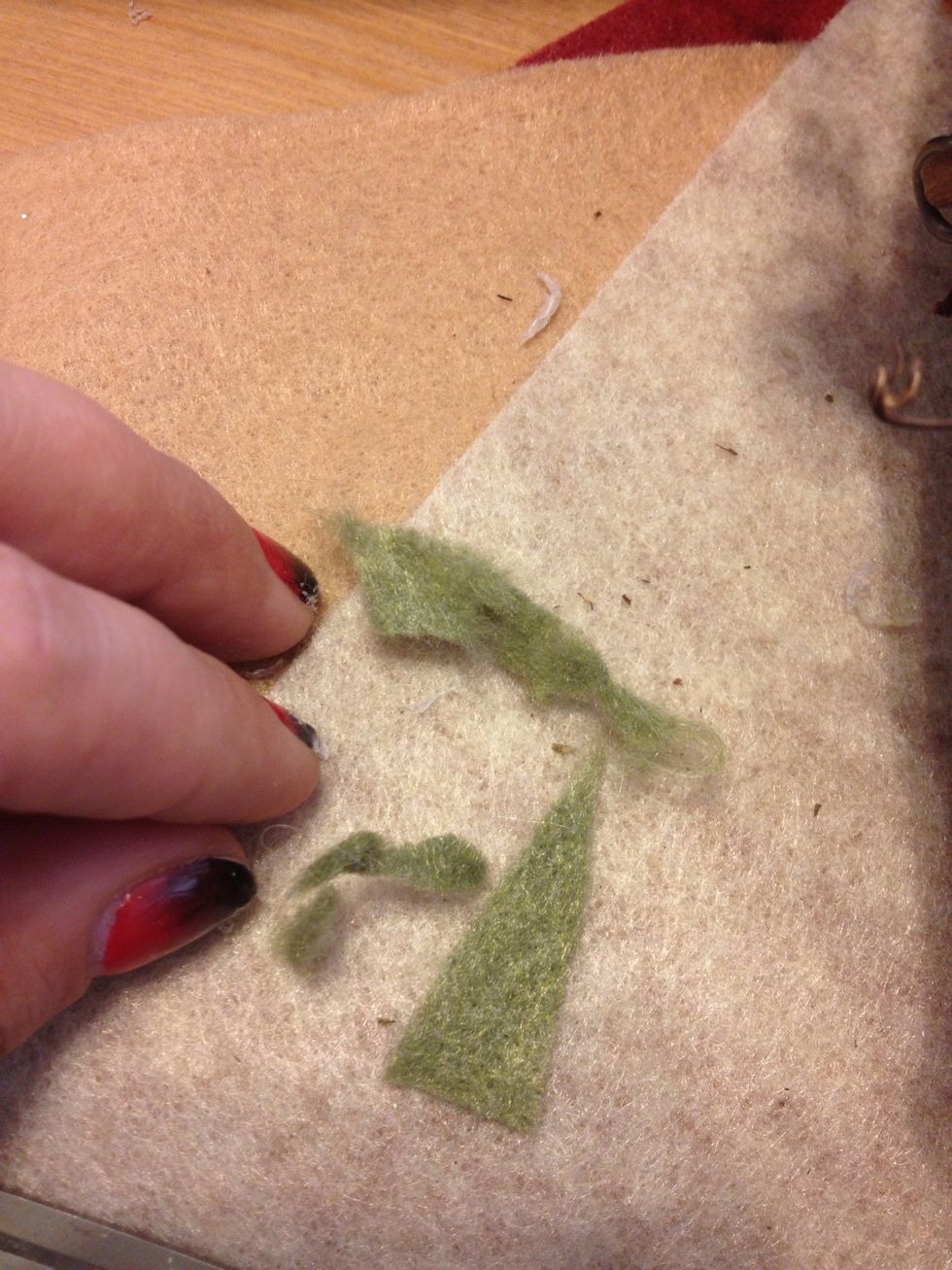 Now take some small pieces of olive green felt and tear some edges...