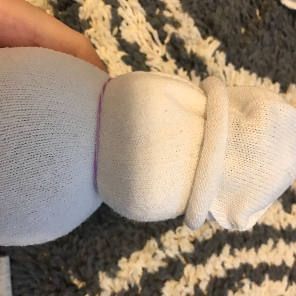 Now take string or a rubber band and tie it around so you can make the head