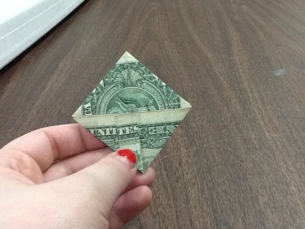 Now, take the bottom flap of the section you've just folded over, and fold it back up. Fold it as far back as you can, being careful not to rip your dollar. Make sure there's still a straight line.