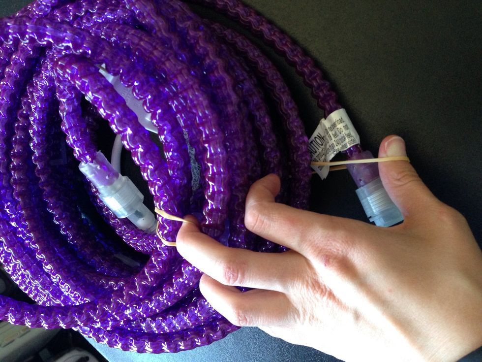 Now take the bottom part of the cord and feed the end of the lights into it.