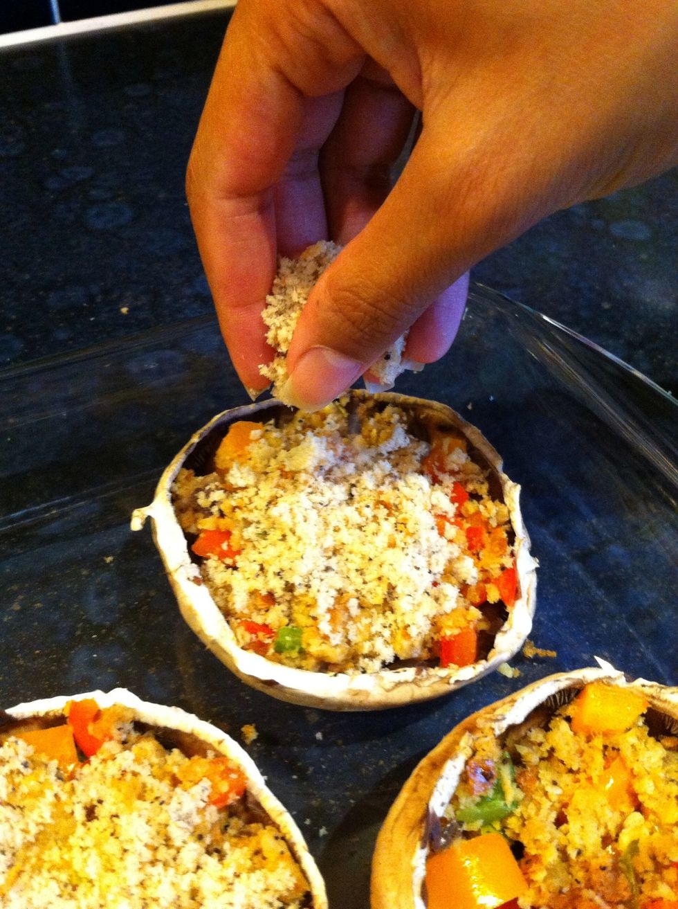 Now take the breadcrumbs you left aside earlier and sprinkle some onto each mushroom