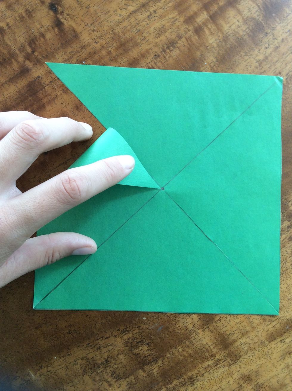 Now take the corner of your scare and bend (not fold) it in