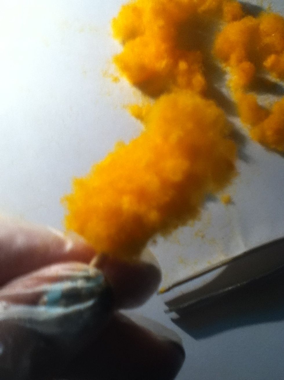 Now take the cut up yarn and put it on to your nails
