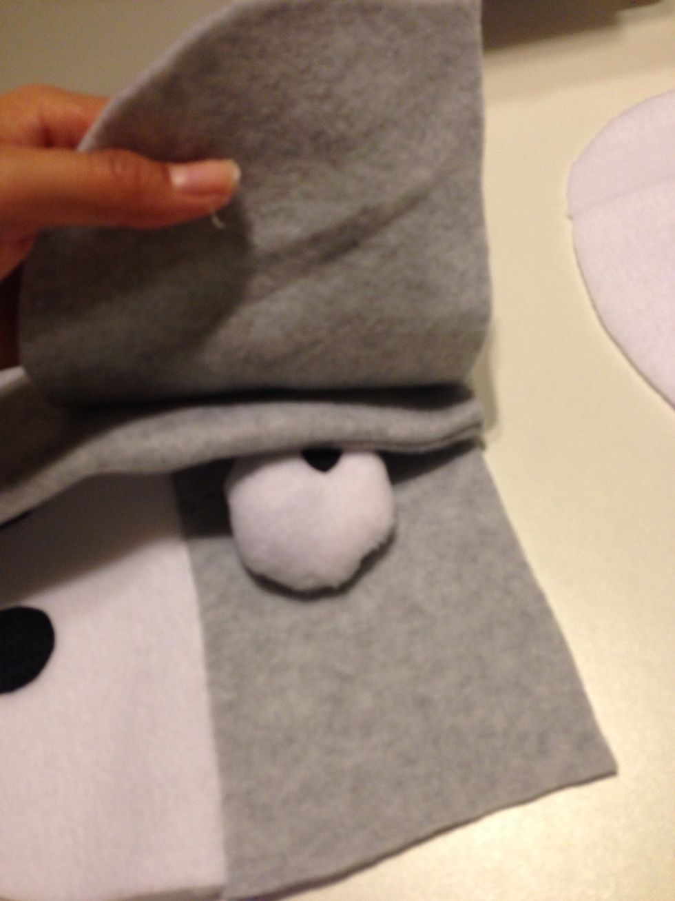 Now take the ears and place the front ear face down on the donkey head. Shown here. Do the same for the other ear