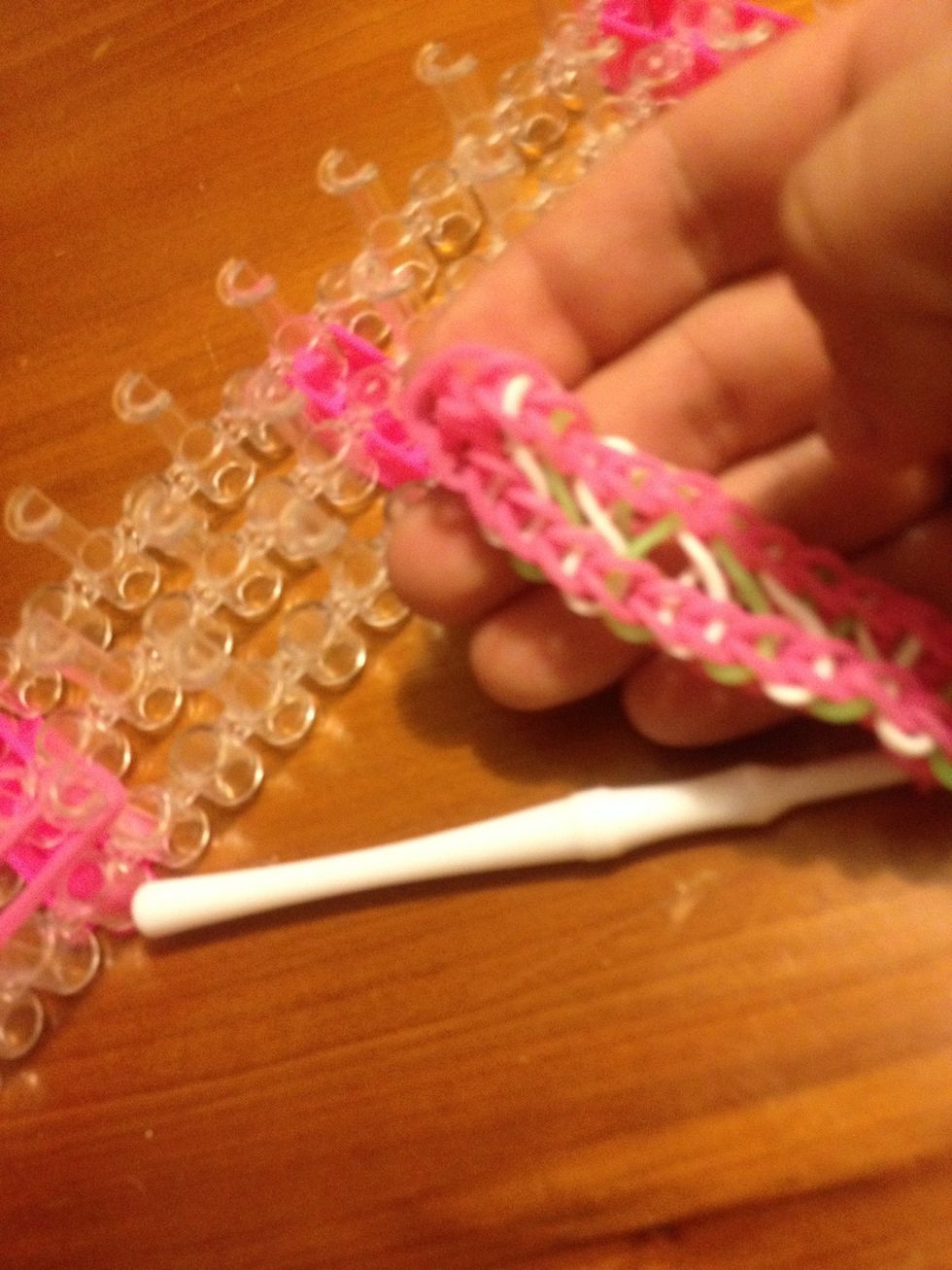 Now take the end where you hook is and stretch it over the last pin with the Double band to the next pin up