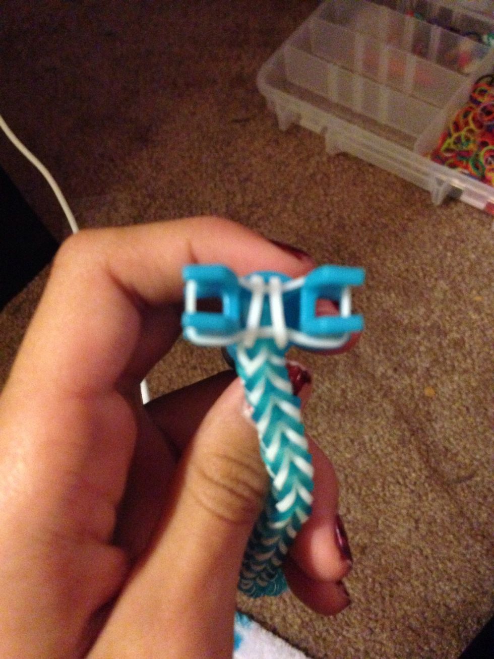 Now take the last rubber band that is on top which in my case is white