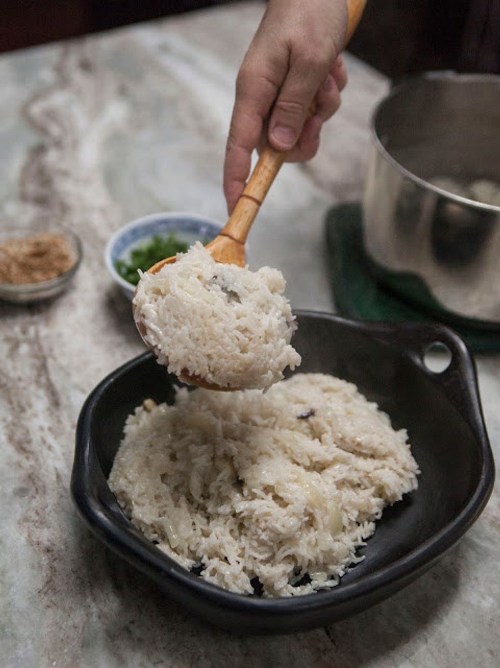 now take the lid off. Place the rice into a serving bowl.