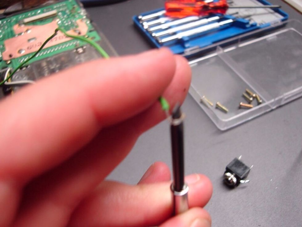 Now take the longer ends of the wire and wrap them around the end of a flat head mini screwdriver. this will make a little "hook" at the end of the wire (that's why we made them a bit longer).