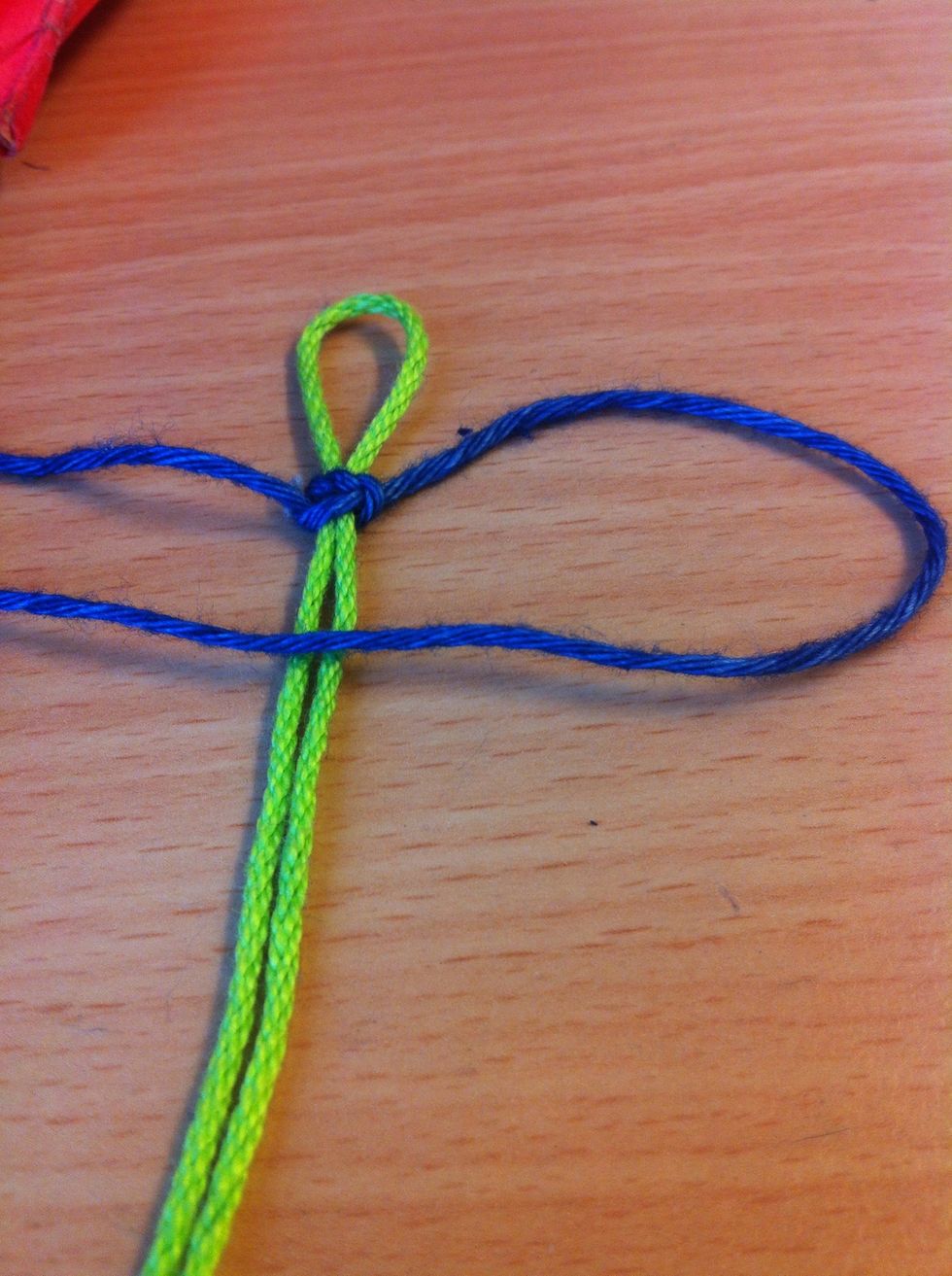 Now take the other piece of yarn and do the same thing. Over the green