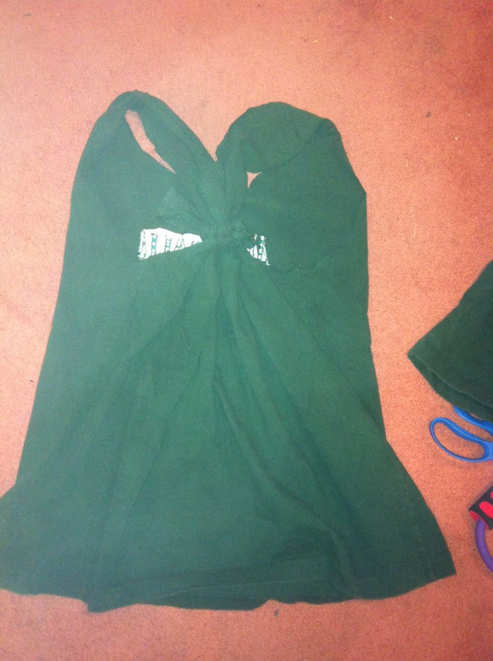 Now take the rectangle scrap and tie the sleeves in the back together like so