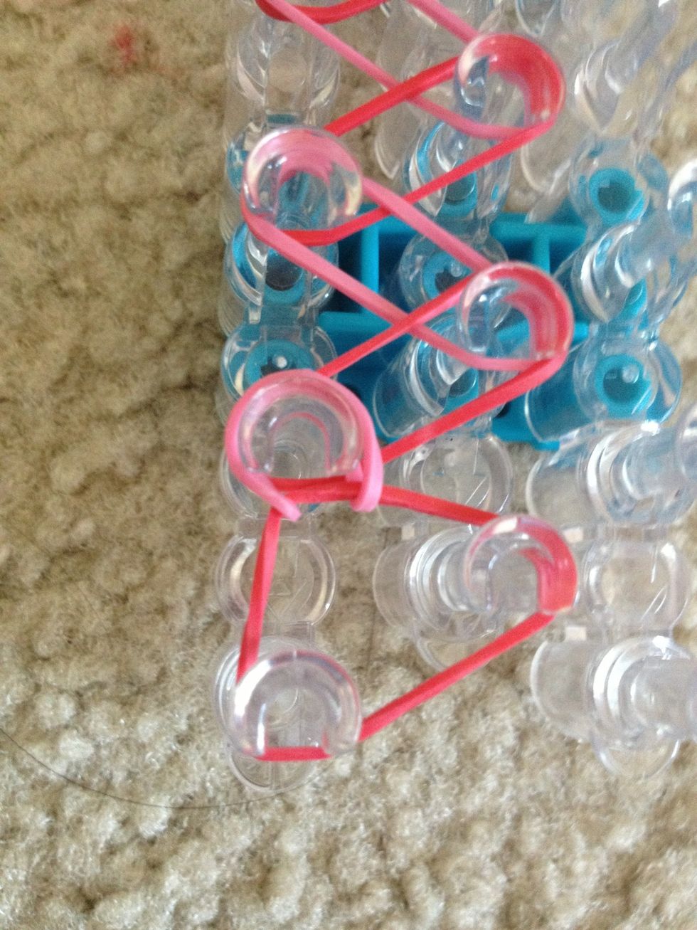 Now take the rubber band under the first and put it back where it came from.