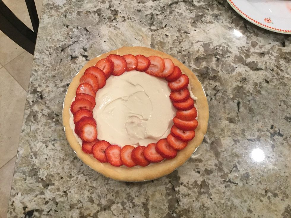 Now, take the strawberries and cut them (make sure to cut them into 1/4 inch slices to have a good placement) and place them around the edge.