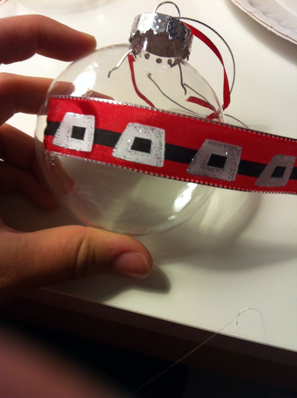 Now take the thicker ribbon and hot glue the first end to the ornament