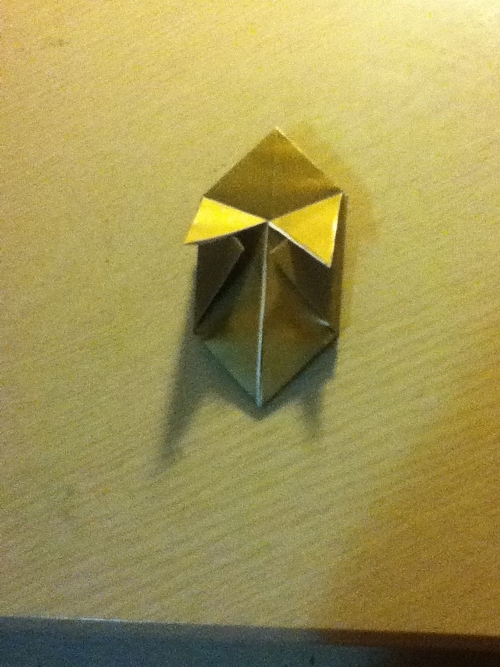 Now take the top most layers AGAIN and fold them down aligning the diagonal edge with the vertical edge like so. Repeat this on the back as well