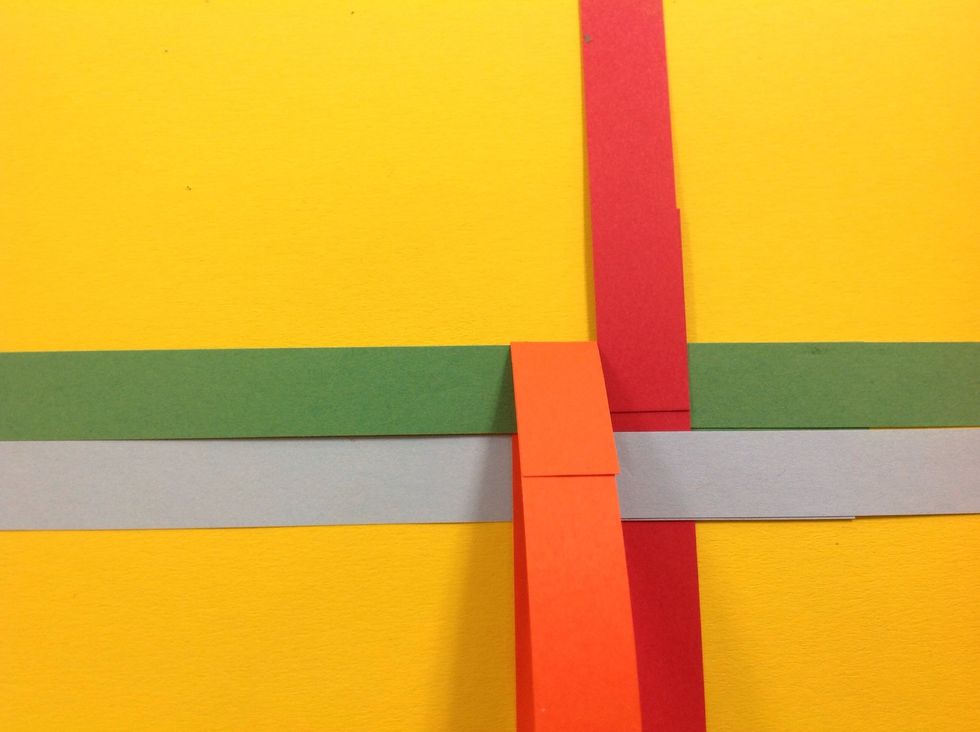 Now take the top right horizontal strip (green) and fold across over the two vertical strips.