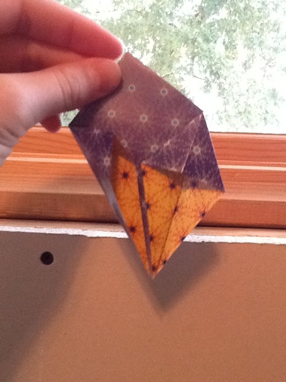 Now take the triangle and press it down to make another kite shape. Do the same to the other half. Turn over and repeat.