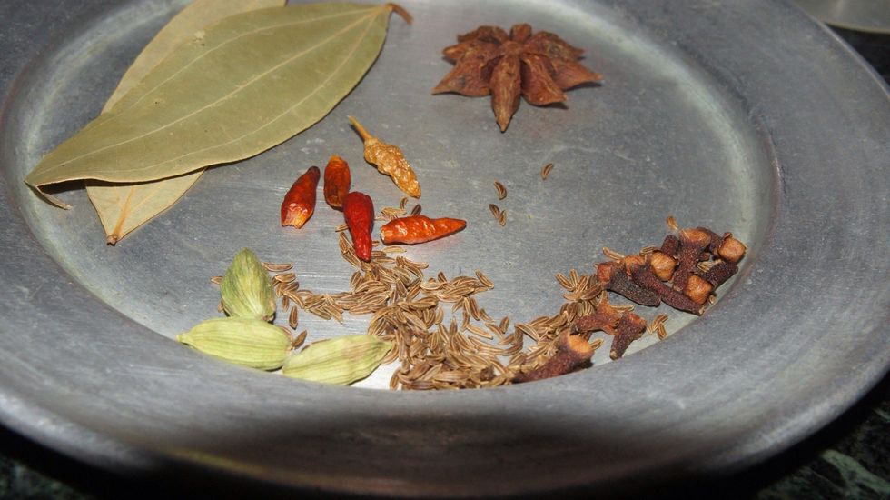 Now take the whole gram masala: short red chilli (add if you want biryani too spicy), bay leafs, cumin seeds, cloves and cardamom.