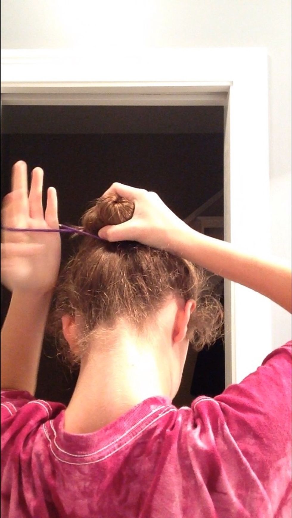 Now take your 2d hair tie and tie your bun in