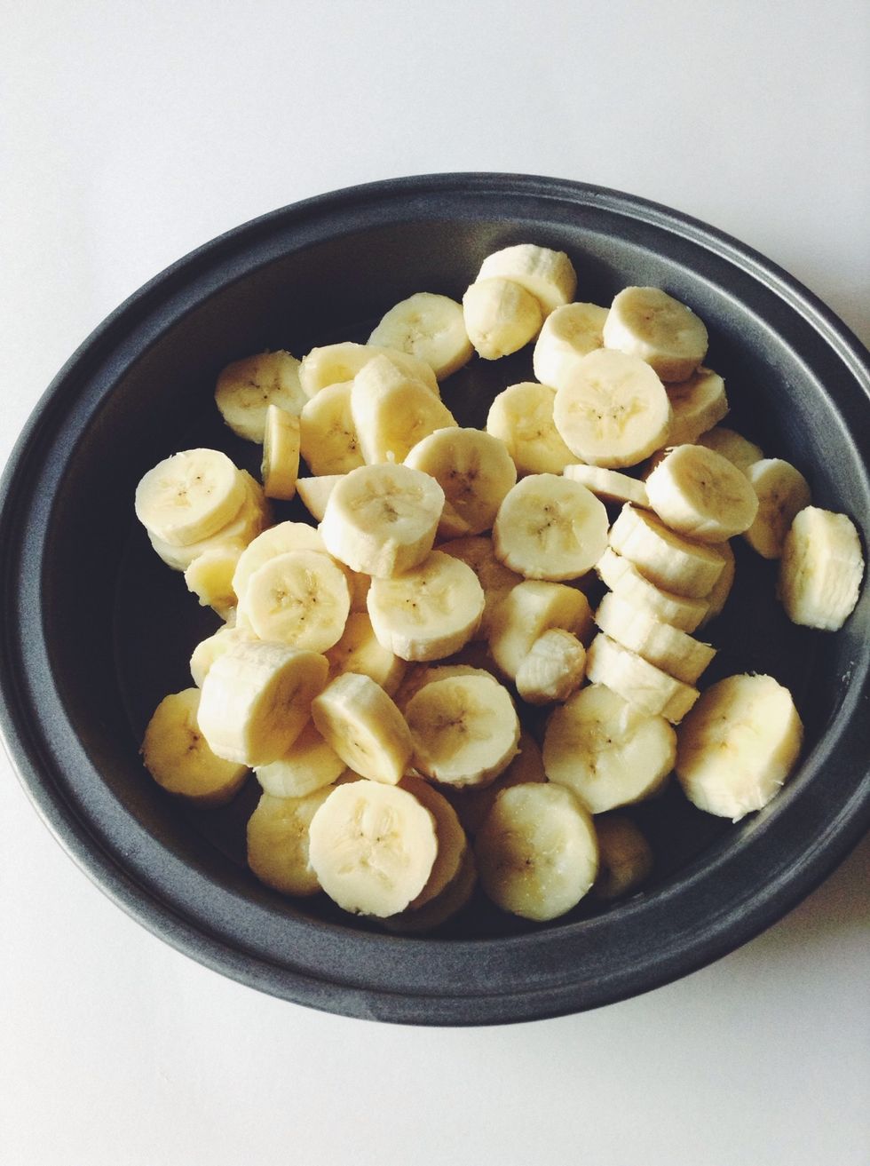 Now take your bananas & put them in a tray, bowl, or what I used, a cake pan. Cover with plastic wrap & put in the freezer for 2 hrs if making the 1 ingredient recipe, or 1 hr for 3 ingredient recipe.