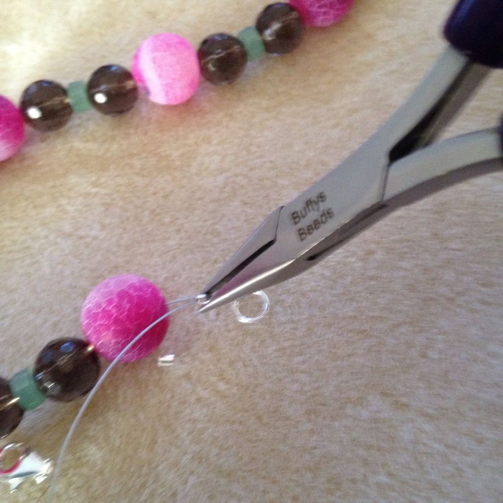 Now take your flat nosed pliers and press the tiny clasp finding together to hold in place