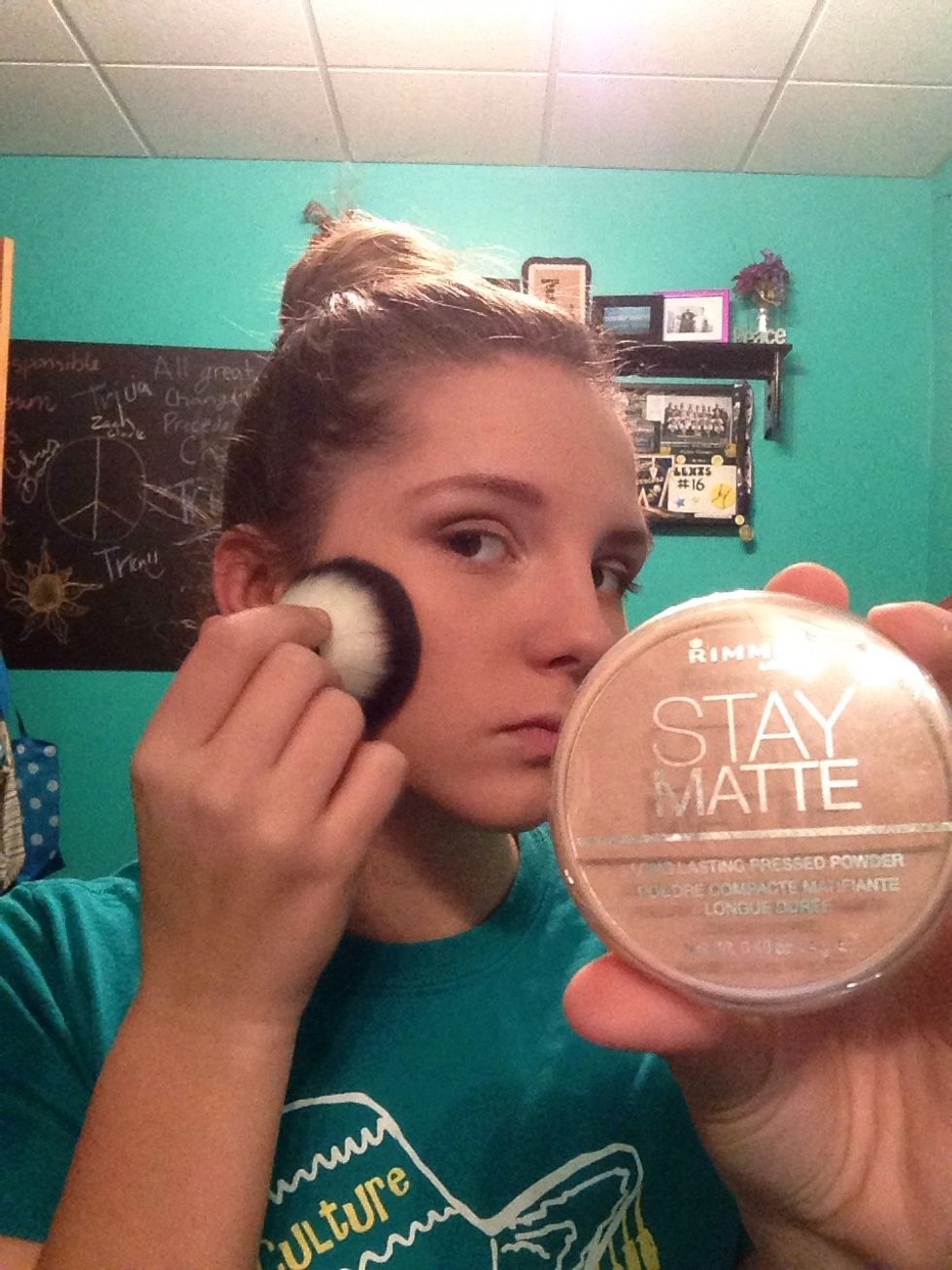 Now take your foundation, I use Rimmel Stay Matte, and the kabuki brush and brush an even coat of foundation on your face and neck.