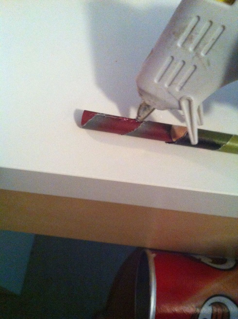 Now take your hot glue gun and glue the paper to the container