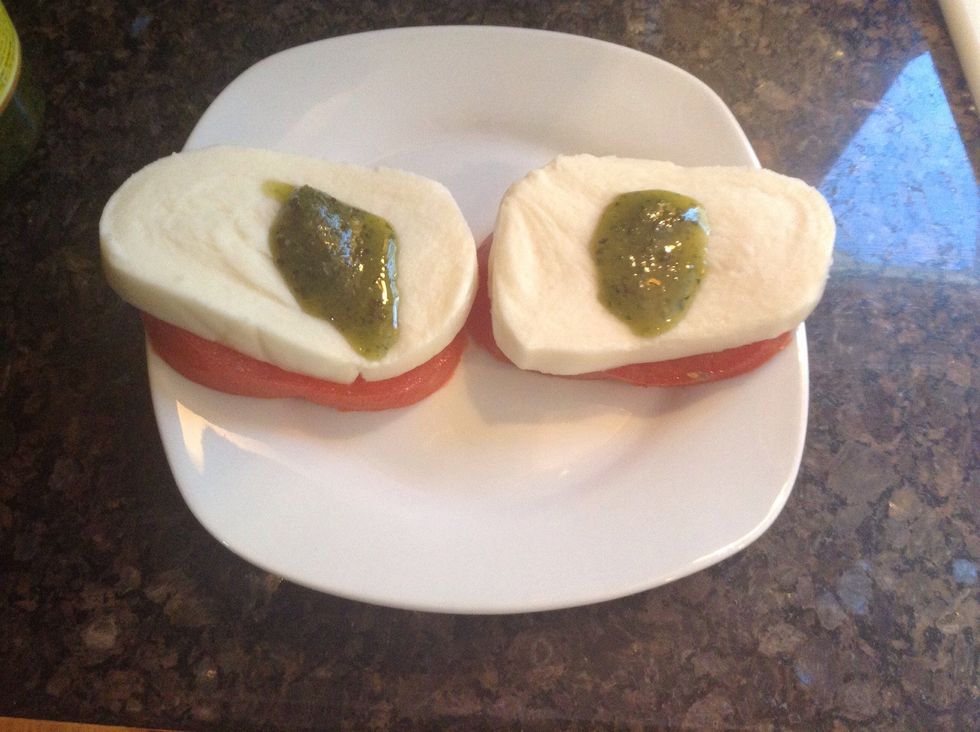 Now take your pesto and put a teaspoon of it over the mozzerella