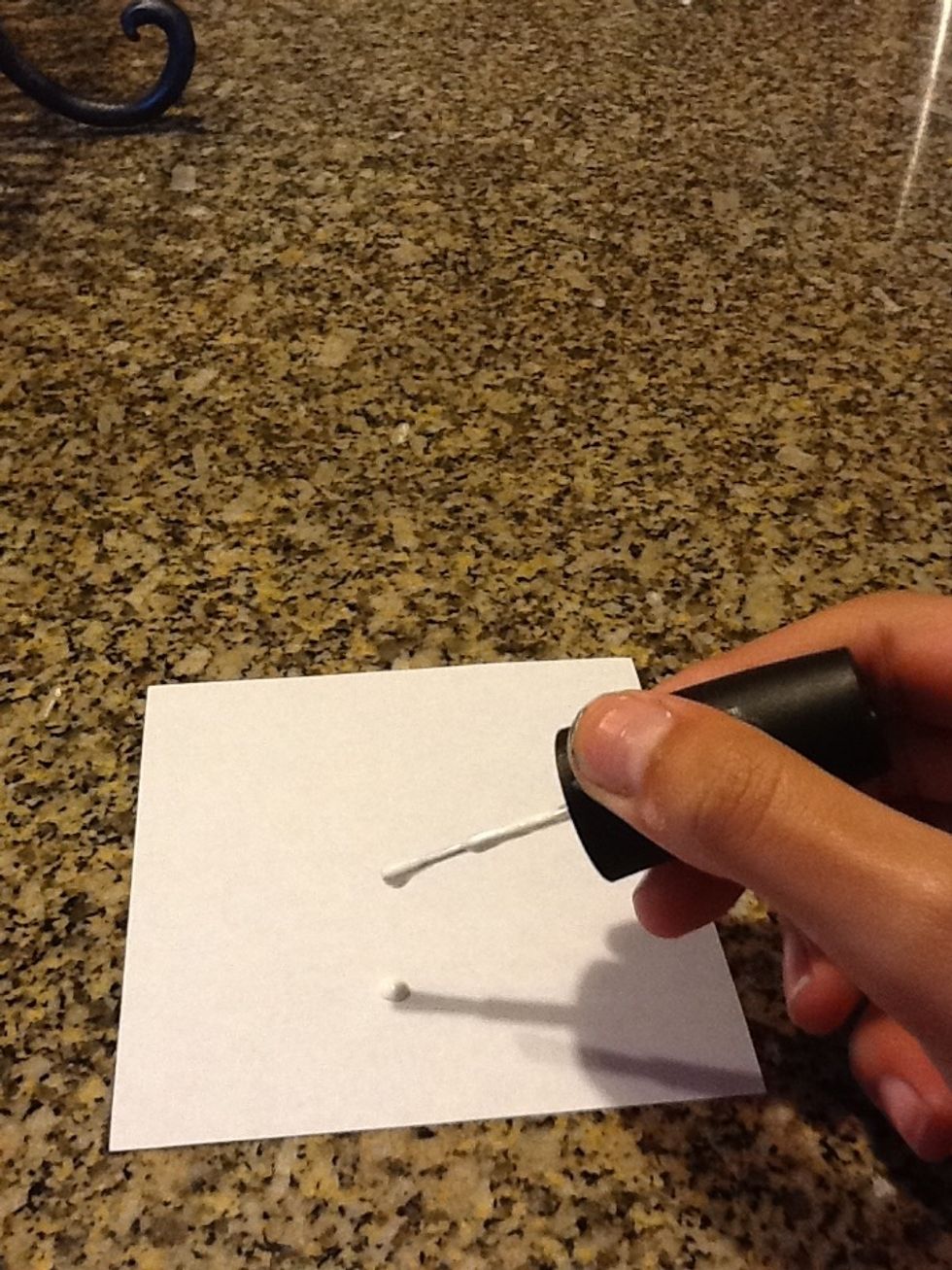 Now take your piece of paper and add a blob of white nail polish