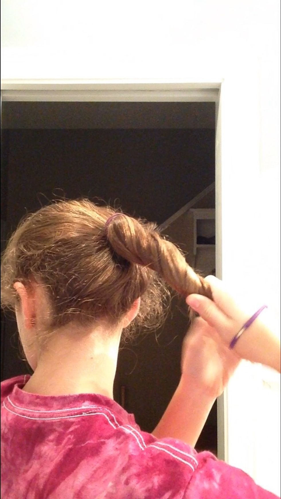 Now take your ponytail and start to twist it. Let me just say that this is way easier without layered hair.
