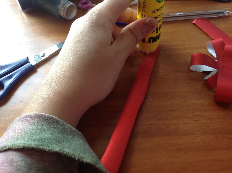 Now take your two remaining strips and add glue at the top portion.