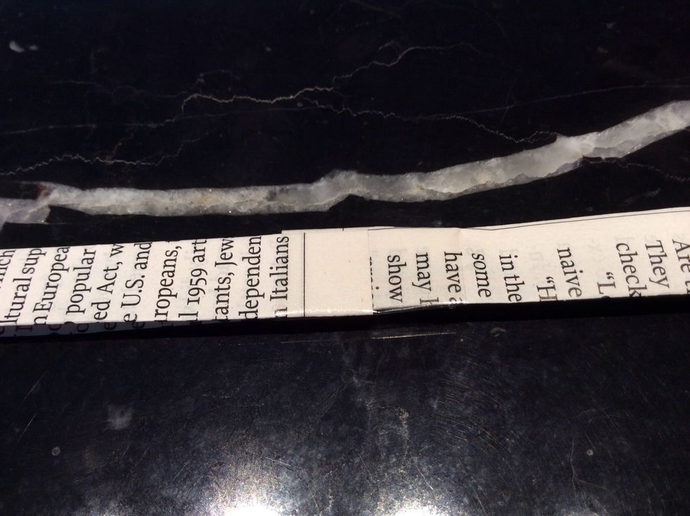 Now tape all of the paper strips together like this. And beware because it will make a LOOONG string of paper strips.