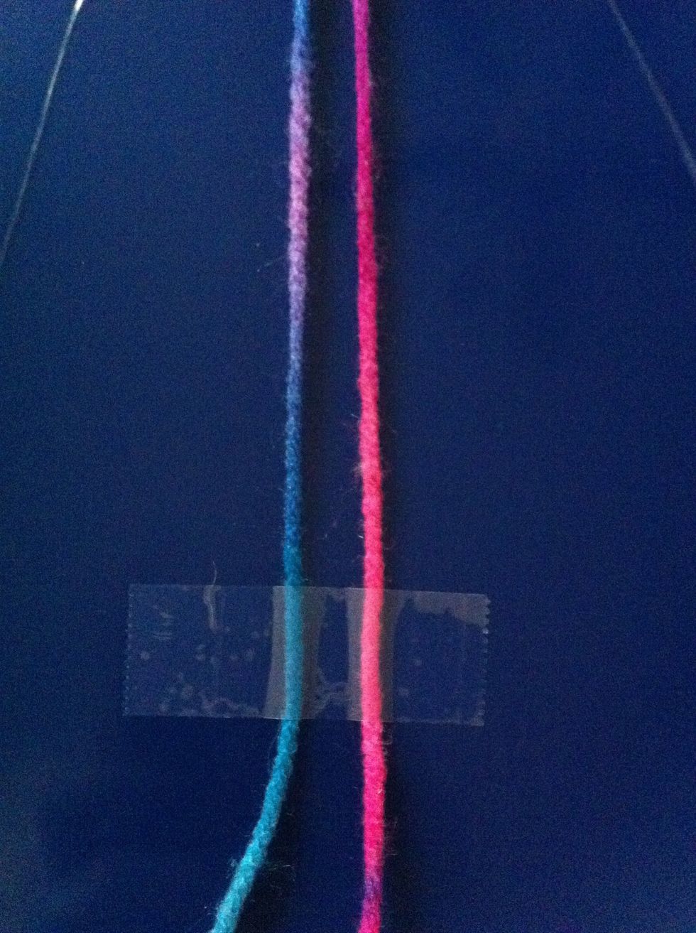 Now tape the yarn a finger space away at the bottom of the strands like in the photo.