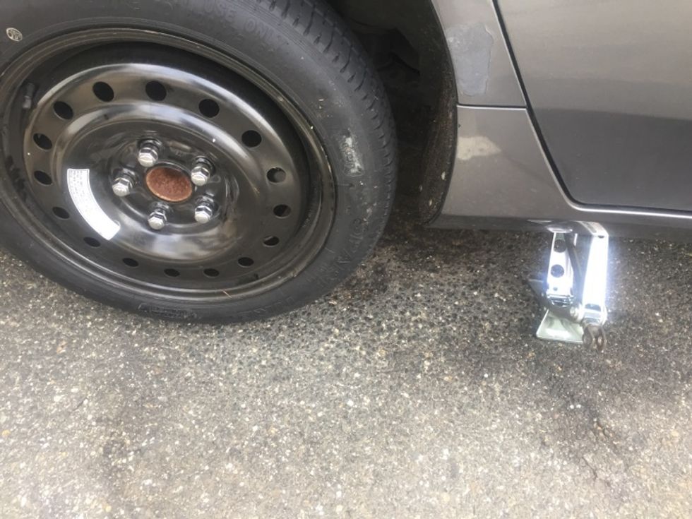 Now, that all the lug nuts are secure, you can lower the car.