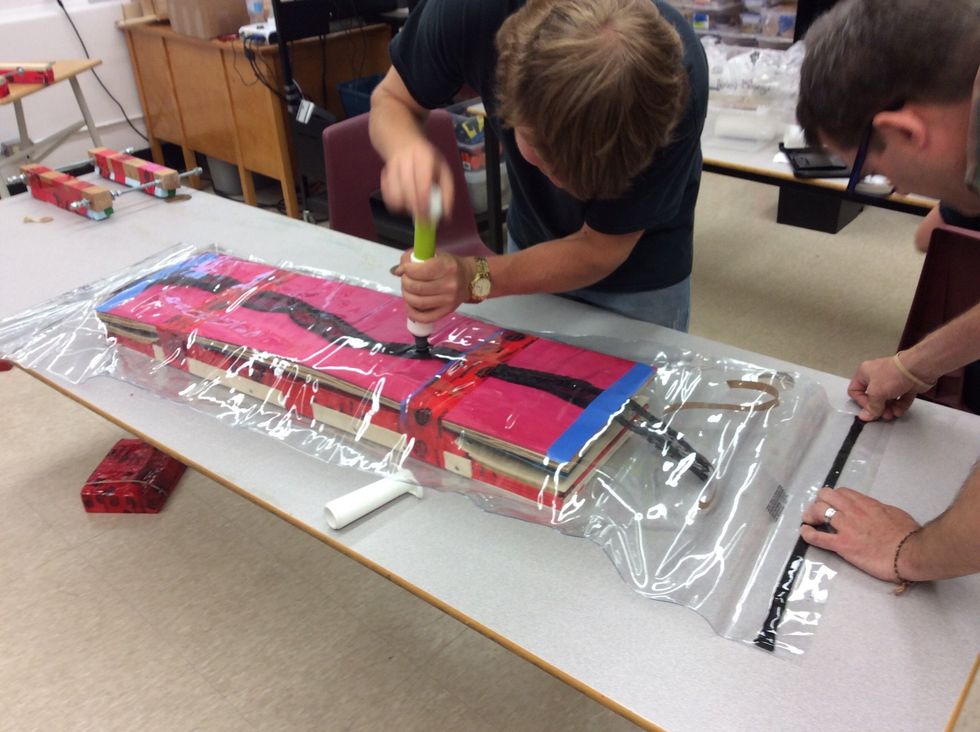 Now that it's sealed, grab the super pump and the small pump and start pumping the air from the bag, be sure to watch your seams so that the bag doesn't get pitched or ruined.