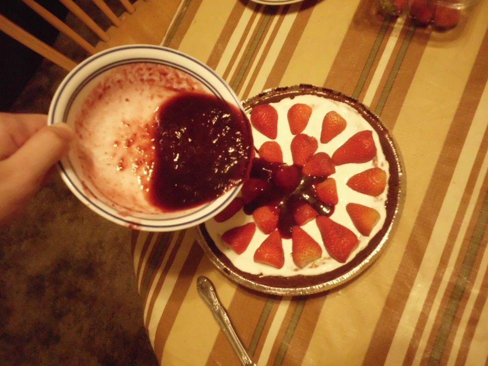 Now that the jelly is heated, pour it onto the cheese cake. Then put it in the refrigerator for a coup of minutes or an hour, or two.