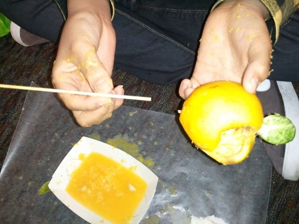 Now that the mummy has been prepared, push the head and body close together and cut off  the excess skewer.  Leave a small piece sticking out of the citrus.  Adult scissors will easily cut the skewer.