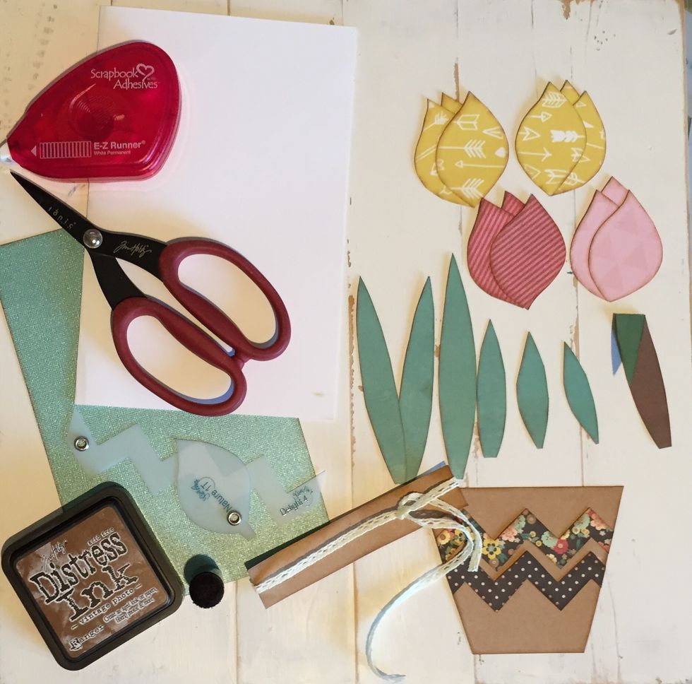 Now that we have everything we need, we are going to start adhering everything to our card base.